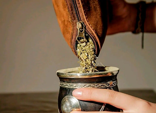 Persona colocando yerba en un mate