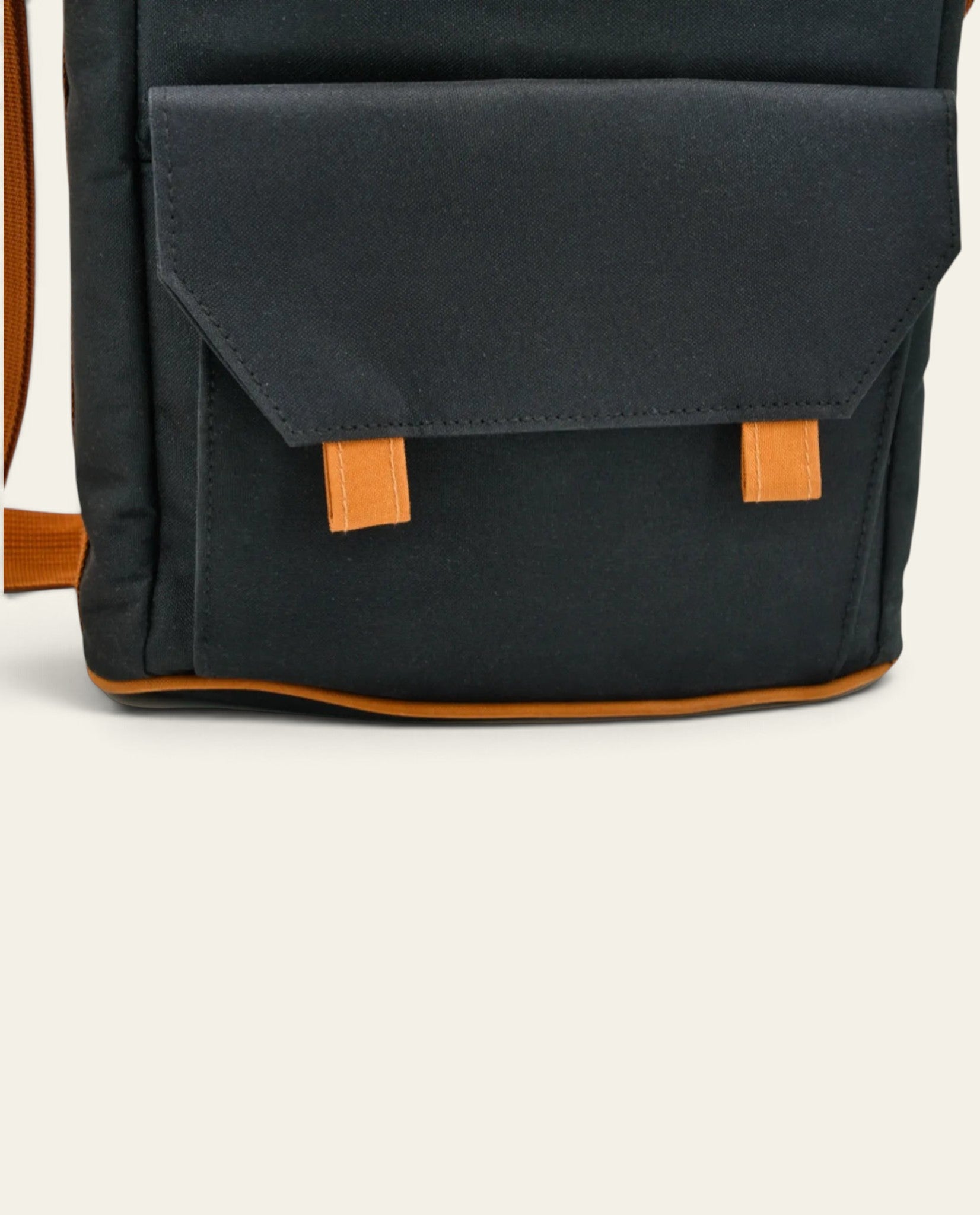 Boldo matero bag in black with orange accents, featuring a front pocket and adjustable shoulder strap.